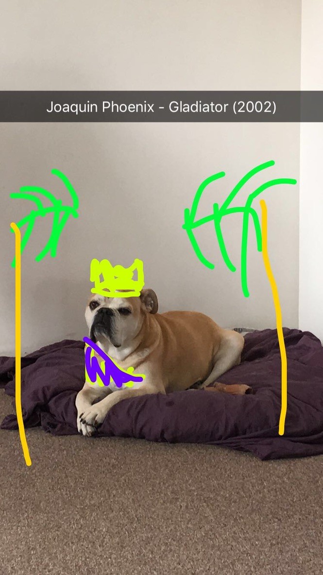 Monto lounging like an emperor with a drawn-on crown, captioned ‘Joaquin Phoenix - Gladiator (2002)’